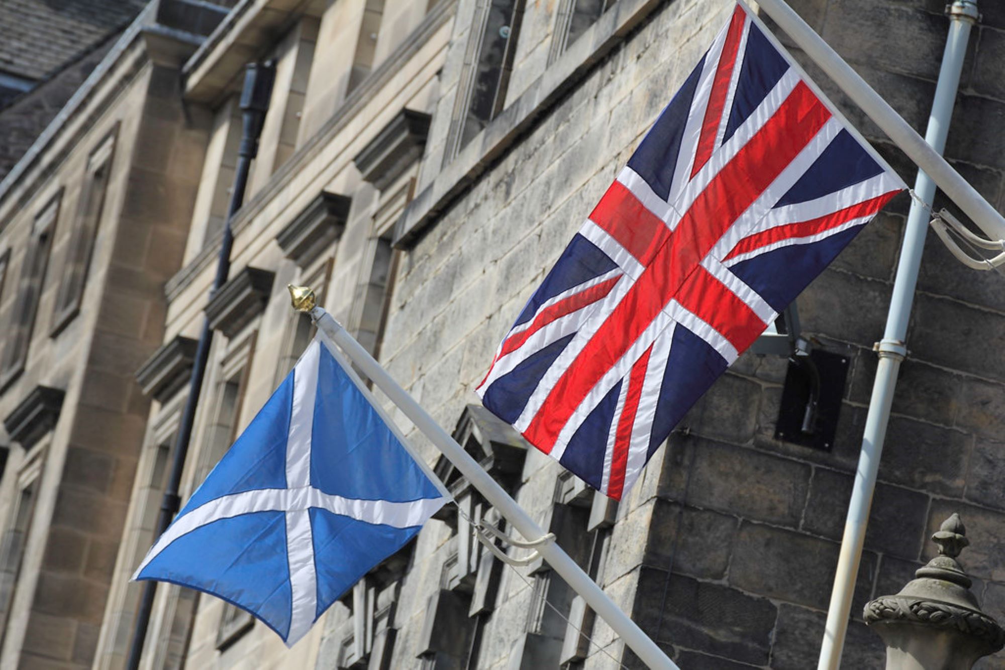 The Scottish Saltire and the British Union Jack, Edinburgh.  Photo: Lawrence OP, flickr.com.
